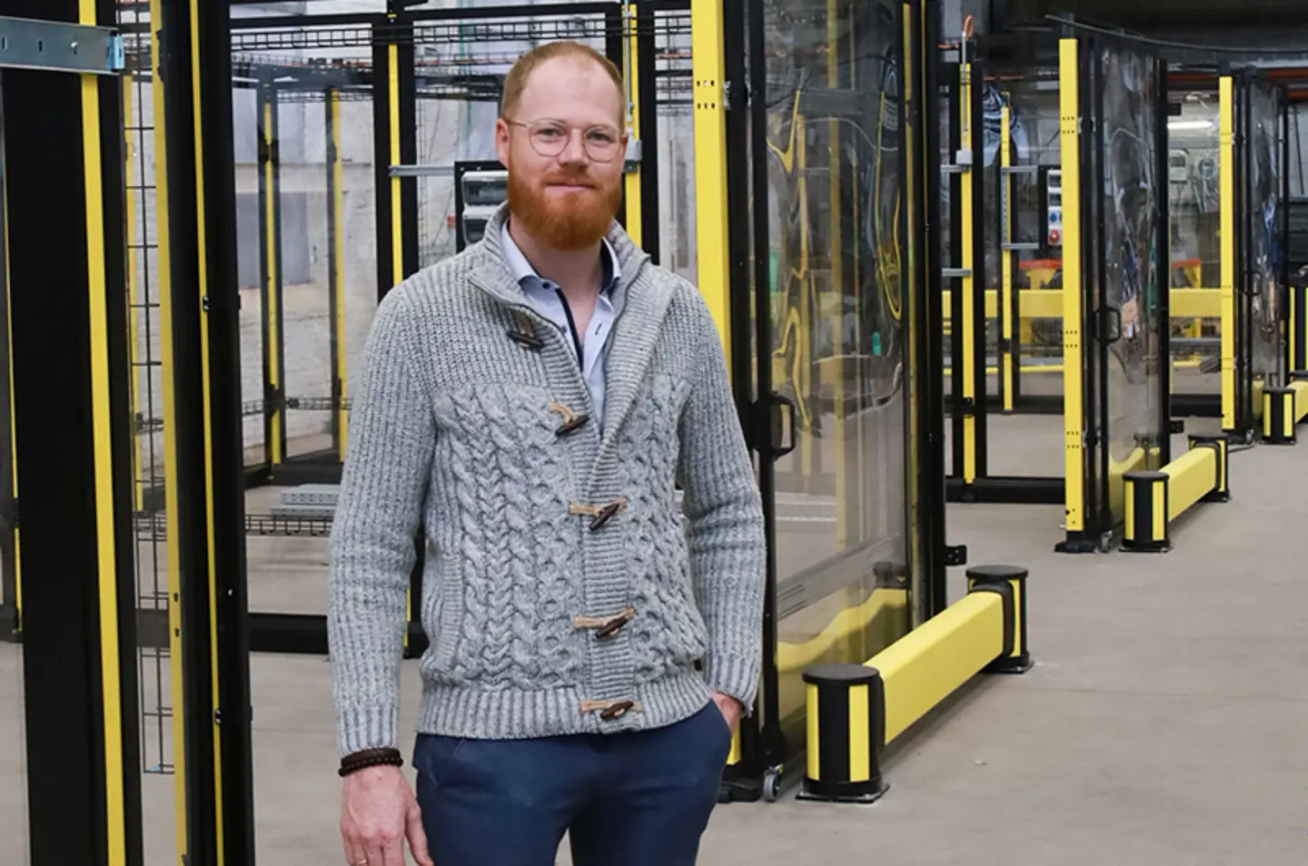 Klaus Clerbout stands in front of new machine guarding cells provided by Axelent. 