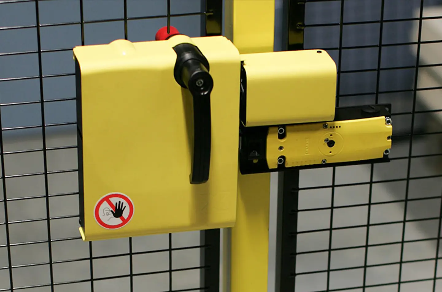 An Axelent X-lock safety and switch door lock system fitted to a mesh machine guarding door